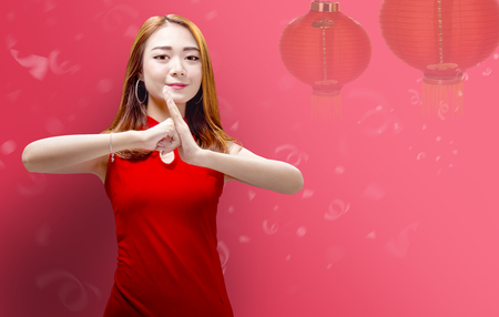 Smiling chinese woman showing congratulation gesture. Happy Chinese New Yearの写真素材