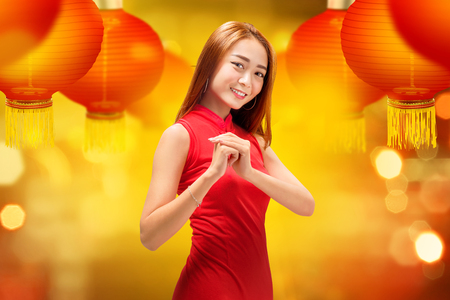 Young chinese woman showing gesture of congratulation. Happy Chinese New Yearの写真素材