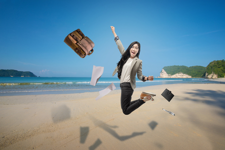 Happy asian business woman taking vacation on the beach. Free from workの写真素材