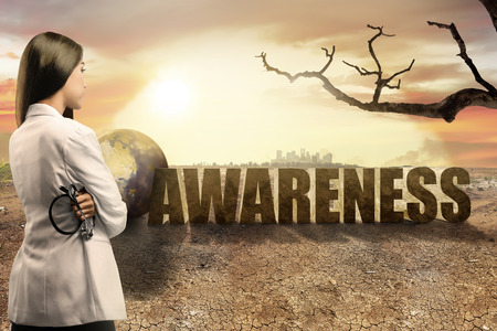 Pretty asian doctor woman with stethoscope looking at global warming effect for environment. Global awareness conceptの写真素材
