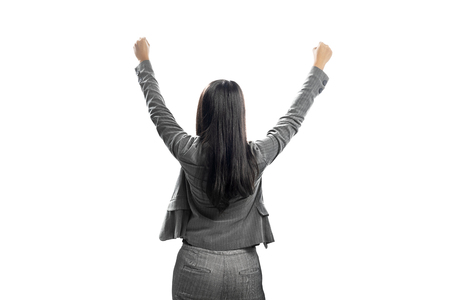 Rear view of asian business woman celebrating her successful posing isolated over white backgroundの写真素材