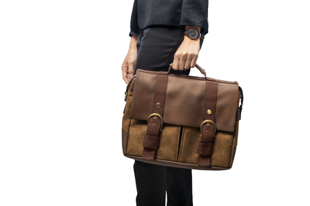 Businesswoman carrying briefcase standing isolated over white backgroundの写真素材