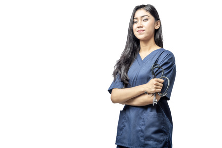 Smiling asian doctor woman with stethoscope on her hands standing isolated over white backgroundの写真素材