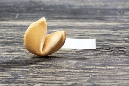 Fortune cookies with blank paper on the wooden tableの写真素材