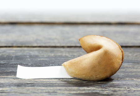 Fortune cookies with blank paper on the wooden tableの写真素材