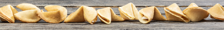 Row of fortune cookies on the wooden tableの写真素材