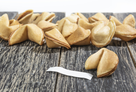 Fortune cookies with blank paper on the wooden tableの写真素材
