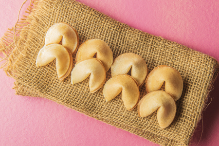 Fortune cookies on the napkin over pink backgroundの写真素材