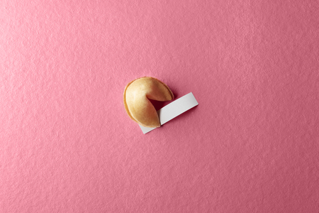 Fortune cookie with blank paper on the pink backgroundの写真素材