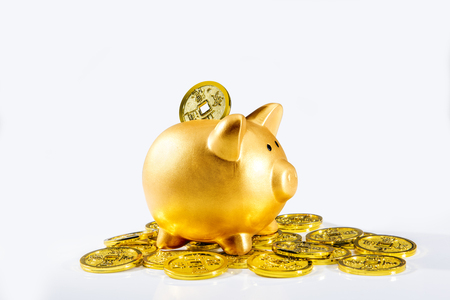 Piggy bank standing on pile of golden coins isolated over white background. Chinese New Years. Year of the earth pigの写真素材