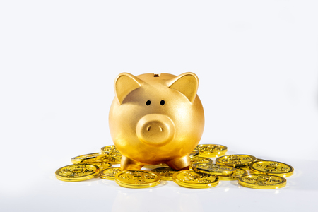 Piggy bank standing on pile of golden coins isolated over white background. Chinese New Years. Year of the earth pigの写真素材