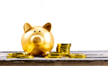 Piggy bank and golden coins on the wooden table. Chinese New Year. Year of the earth pigの写真素材
