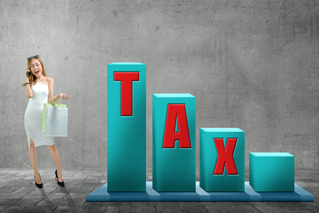 Beautiful asian woman with shopping bags and taxes text on the increases chart. Taxes conceptの写真素材