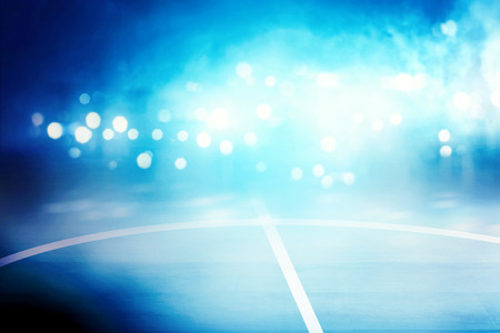 Close up view of basketball court with blue spotlights backgroundの写真素材