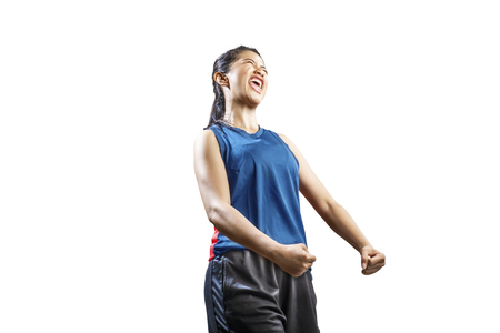 Excited asian basketball player woman expressing emotions isolated over white backgroundの写真素材