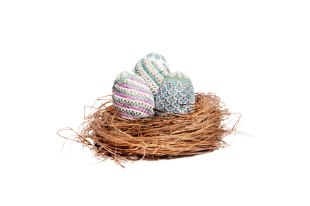 Colorful easter eggs in the nest isolated over white background. Happy Easterの写真素材
