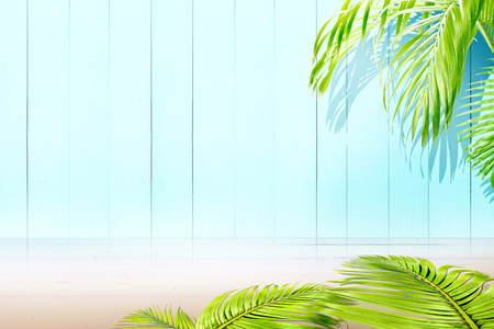 Glossy surface wooden floor and palm branches with blue wooden wall backgroundの写真素材