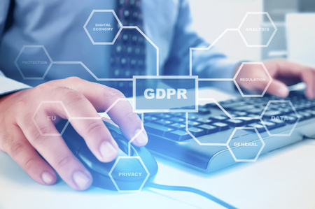 Businessman working with mouse and keyboard on the desk with GDPR protection structure on virtual screen. Cyber security and privacy. General Data Protection Regulation (GDPR) conceptの写真素材