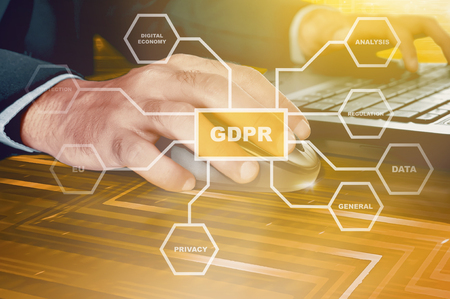 Businessman working with mouse and laptop on the futuristic desk with GDPR protection structure on virtual screen. Cyber security and privacy. General Data Protection Regulation (GDPR) conceptの写真素材