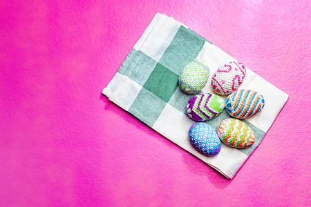 Colorful easter eggs on the napkin with pink color background. Happy Easterの写真素材