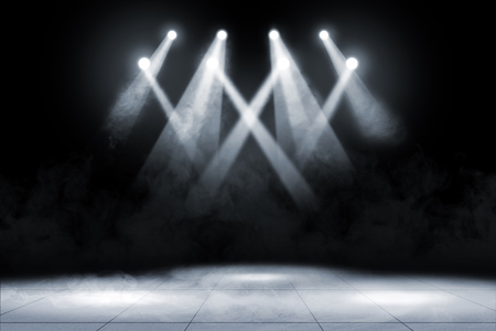 Tile floor with concert spot lighting and smoke over dark backgroundの写真素材