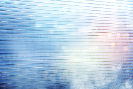 White roller shutter door with smoke and colorful light reflection on metal backgroundの写真素材