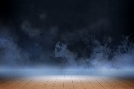 Room with wooden floor and smoke with dark wall backgroundの写真素材