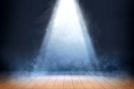 Room with wooden floor and smoke with light from the top against dark wall backgroundの写真素材
