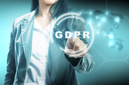 Hand of business woman pointing GDPR text on virtual screen with digital maps connection on the world background. Cyber security and privacy. General Data Protection Regulation (GDPR) conceptの写真素材