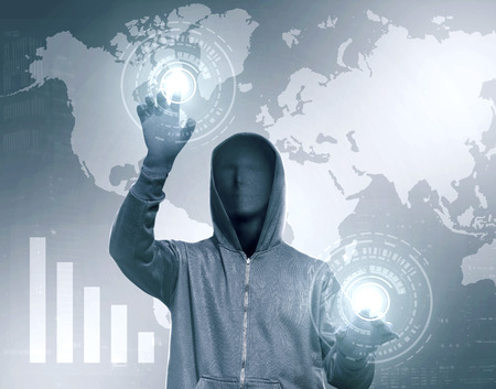 Hacker in black hoodie touching virtual screen with chart bar and world map backgroundの写真素材