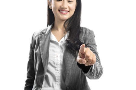 Young asian business woman touch something with her finger hand standing isolated over white backgroundの写真素材
