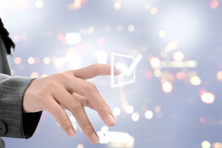 Business woman pointing list to make checkmark on virtual screen. Business conceptの写真素材
