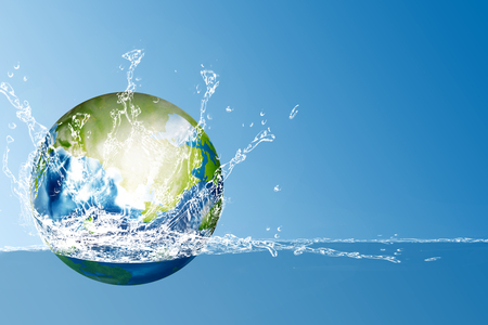 Earth planet on the water with splash over blue background. Earth hour conceptの写真素材