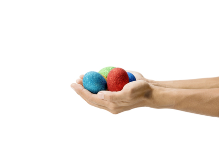 Human hands holding colorful easter eggs isolated over white background. Happy Easterの写真素材