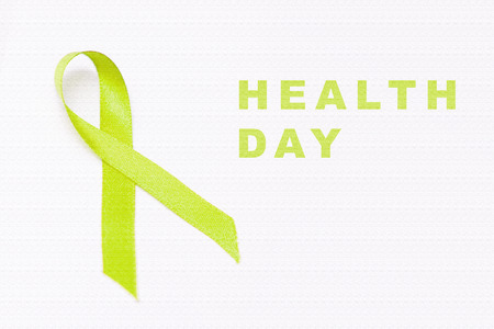 Green ribbon as a symbol of health day isolated over white background. Health day conceptの写真素材
