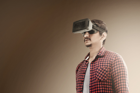 Asian man using virtual reality device. Augmented reality technologyの写真素材
