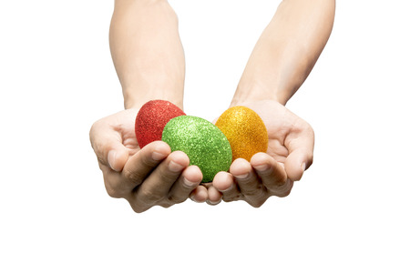 Human hands holding colorful easter eggs isolated over white background. Happy Easter
