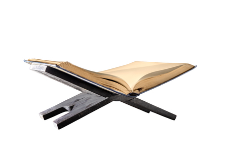 Quran open on wooden placemat isolated over white backgroundの写真素材