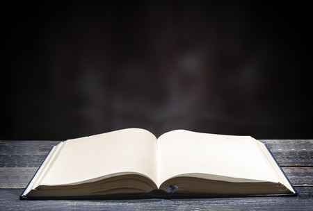 Quran open on wooden table over blurry backgroundの写真素材