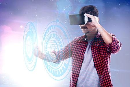 Asian man touching a circle on digital interface with virtual reality device display the world map and binary code. Augmented reality technologyの写真素材