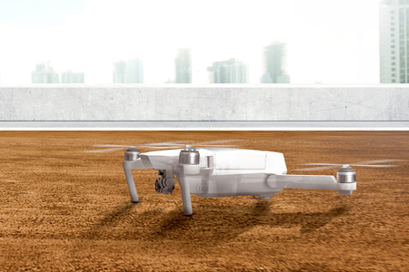 White drone with camera on the rooftop ready to flying to the air with skyscrapers backgroundの写真素材