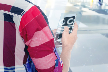 Rear view of man touch the mobile phone screen and display the interface of chart and graphs. Digital technology conceptの写真素材