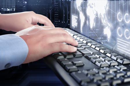 Businessman typing on the keyboard with display interface of world map, chart and graphs over futuristic background. Digital technology conceptの写真素材