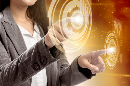 Business woman touch a circle on virtual screen which display the interface of world map and binary code. Digital technology conceptの写真素材