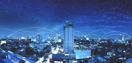 Modern city with internet and communication network over night scene backgroundの写真素材