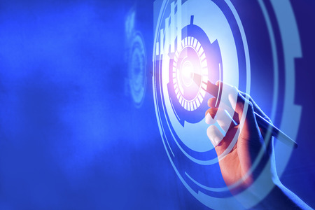 Business hand with marker touching a circle on virtual screen which display the interface of graphs. Digital technology conceptの写真素材