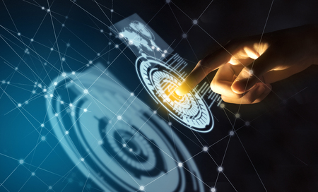 Business finger touching a circle on virtual screen which display the interface of world maps, binary code and business network. Digital technology conceptの写真素材