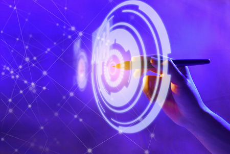 Business hand with markers touching a circle on virtual screen which display the interface of graphs and business network. Digital technology conceptの写真素材