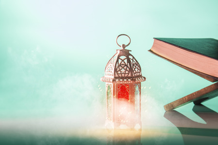Arabic lamp with beautiful light and holy koran. Islamic concept image for ramadanの写真素材