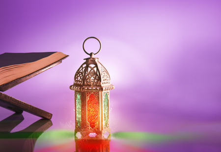 Arabic lamp with beautiful light and holy koran. Islamic concept image for ramadanの写真素材
